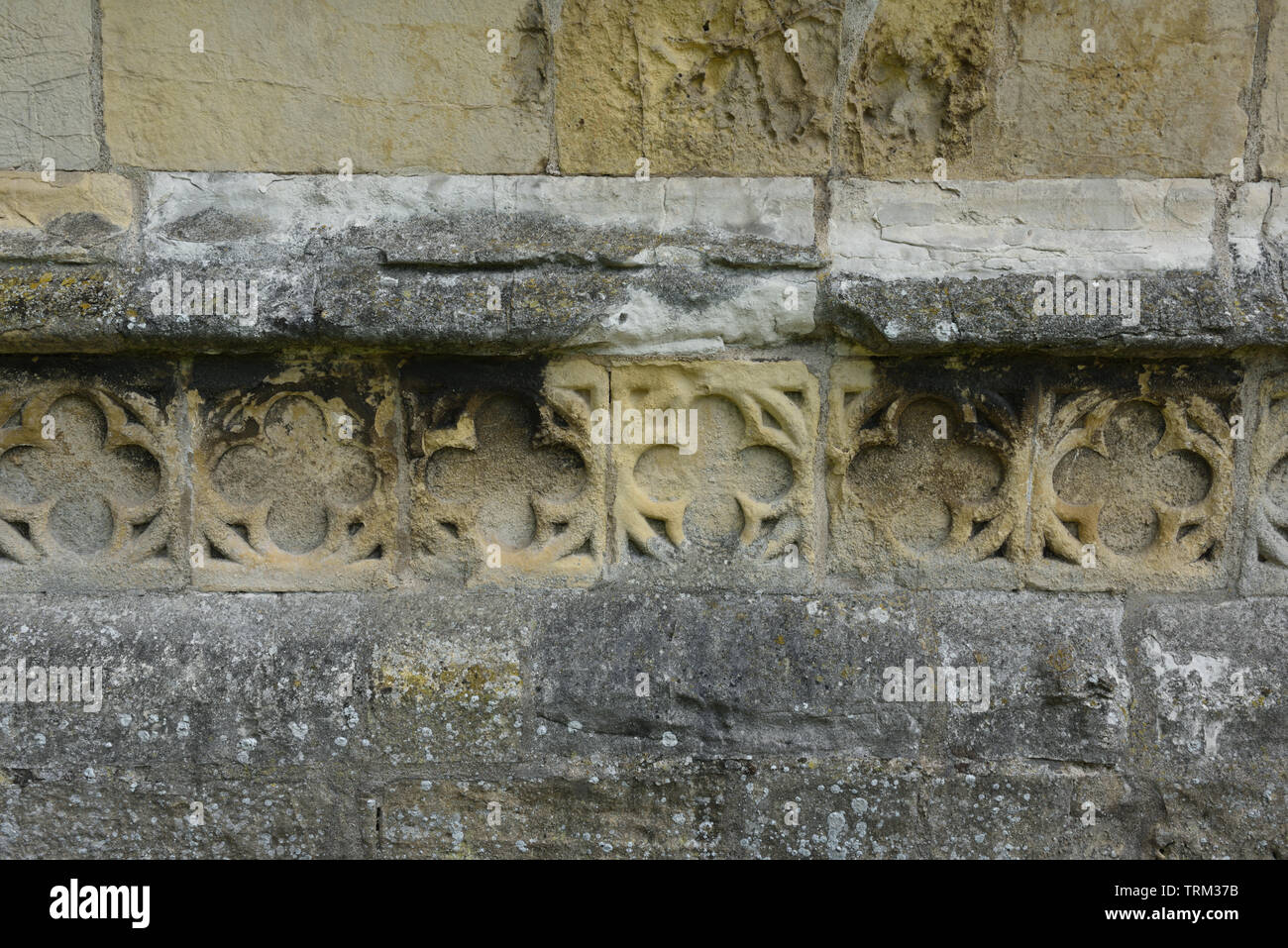 Chamfered plinth with quatrefoil band at the base of the tower of St Augustine's Church, Skirlaugh, East Yorkshire, England Stock Photo