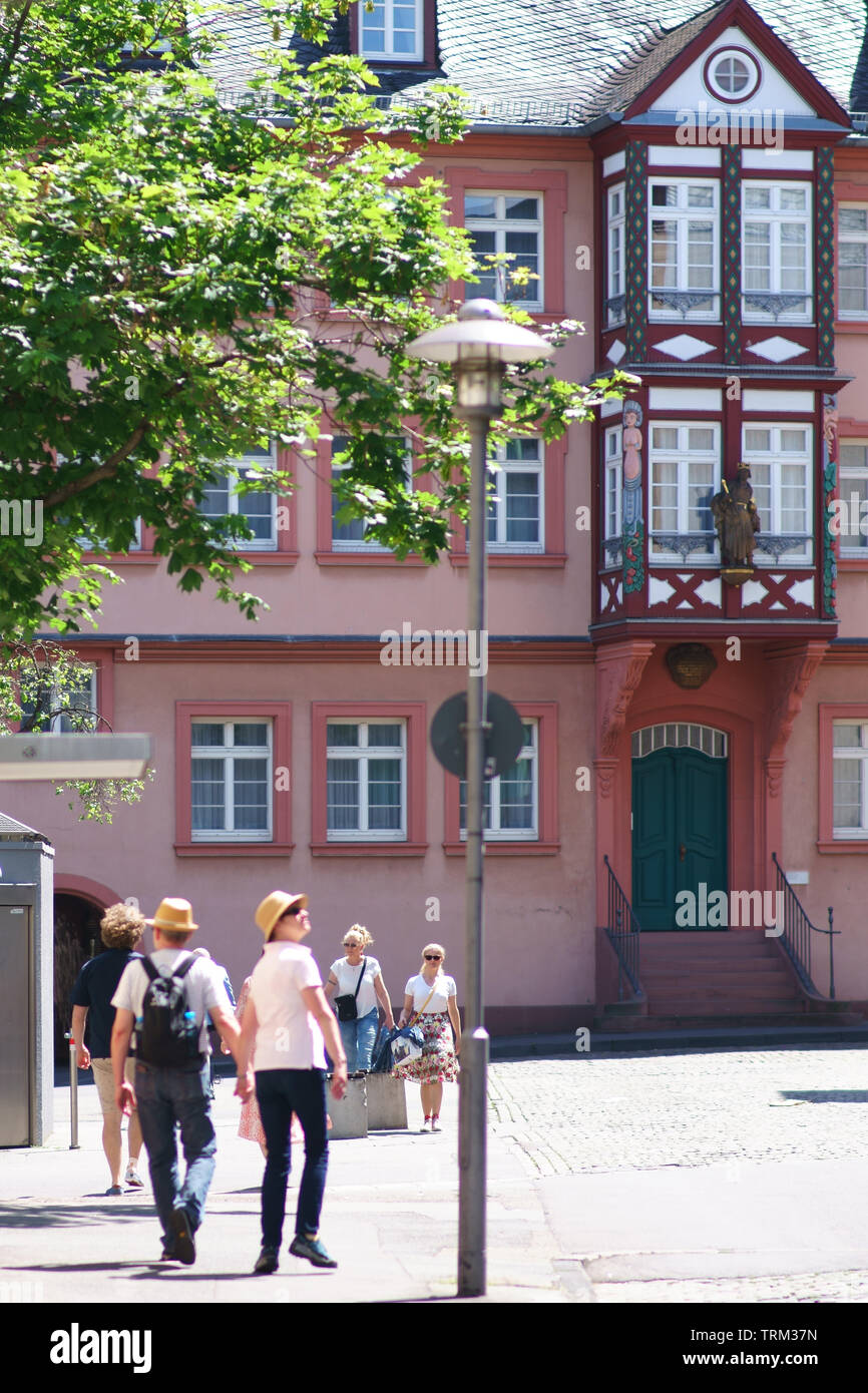 Mainz, Germany - May 27, 2019: tourists and pedestrians on the Gutenbergplatz in front of historic buildings on May 27, 2019 in Mainz. Stock Photo