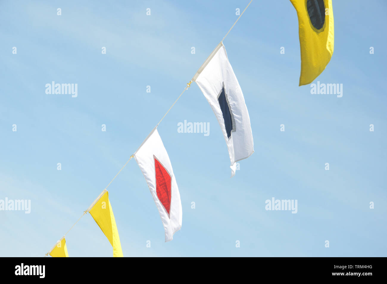 maritime flags against blue sky Stock Photo