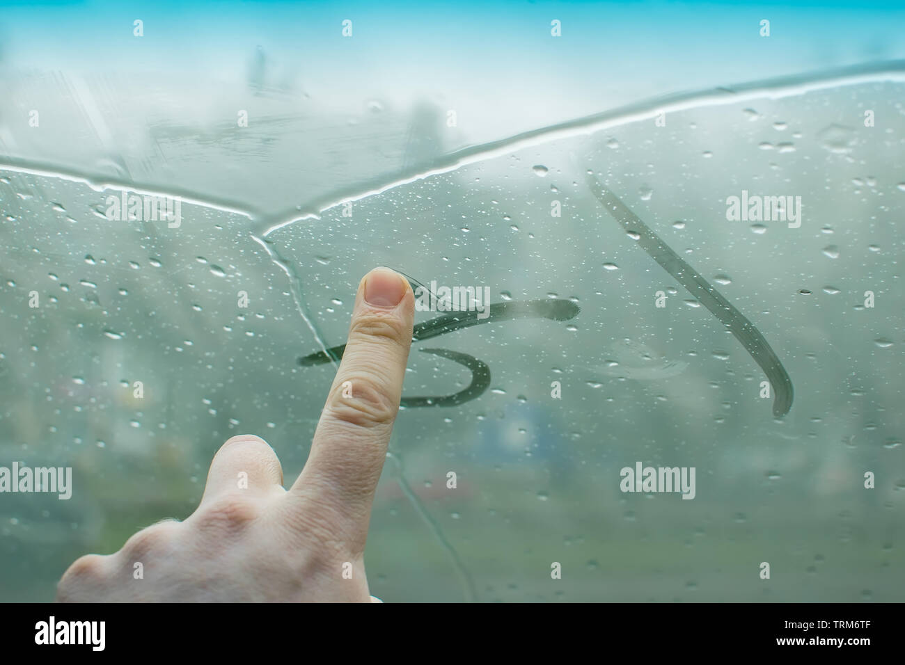 the human hand fingers drawing lines on a sweaty moisture from the