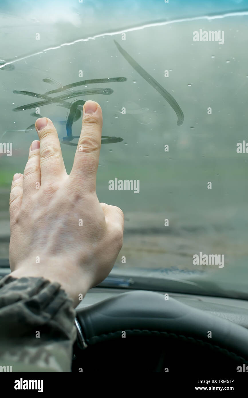 The Human Hand Fingers Drawing Lines On A Sweaty Moisture