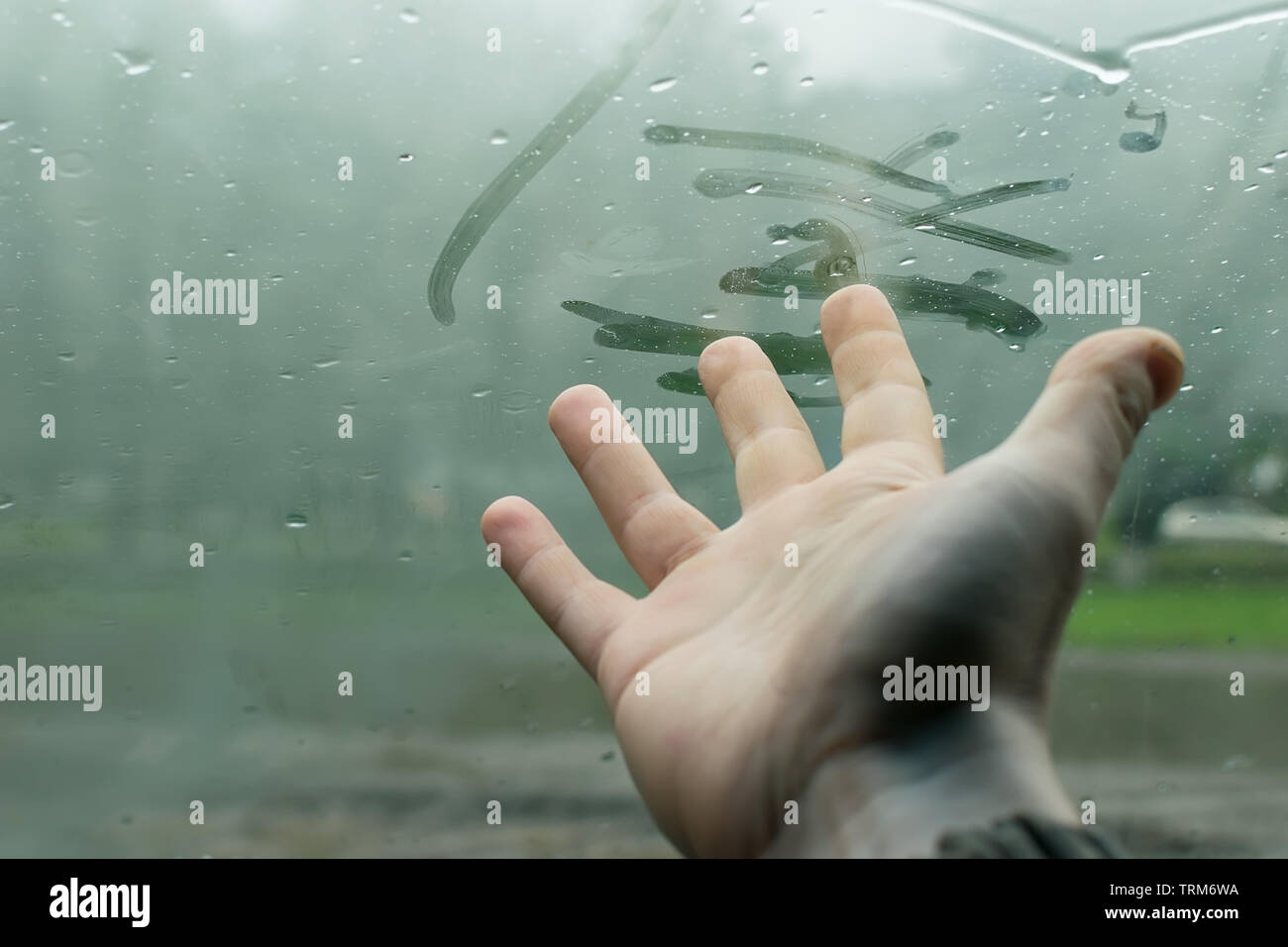 the human hand fingers drawing lines on a sweaty moisture from the