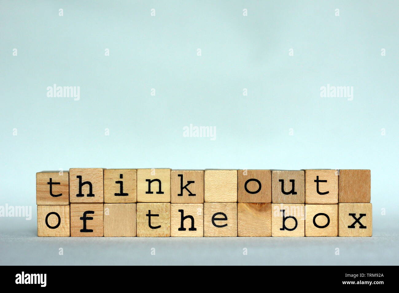 The text 'Think out of the box'  written with small wooden stamps, copy space for text Stock Photo