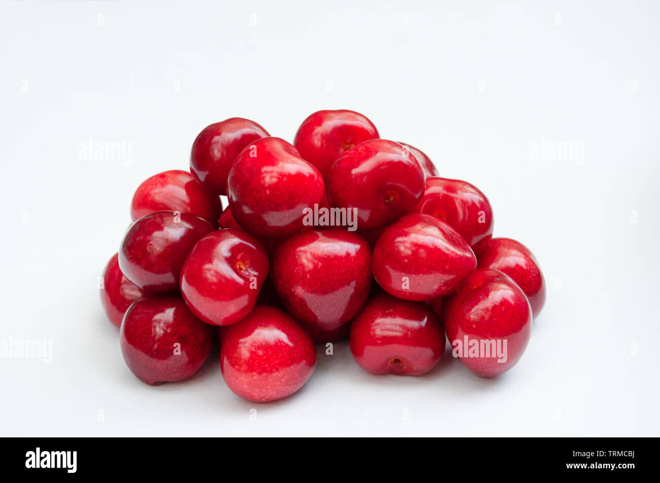Cherries pile on white background Stock Photo