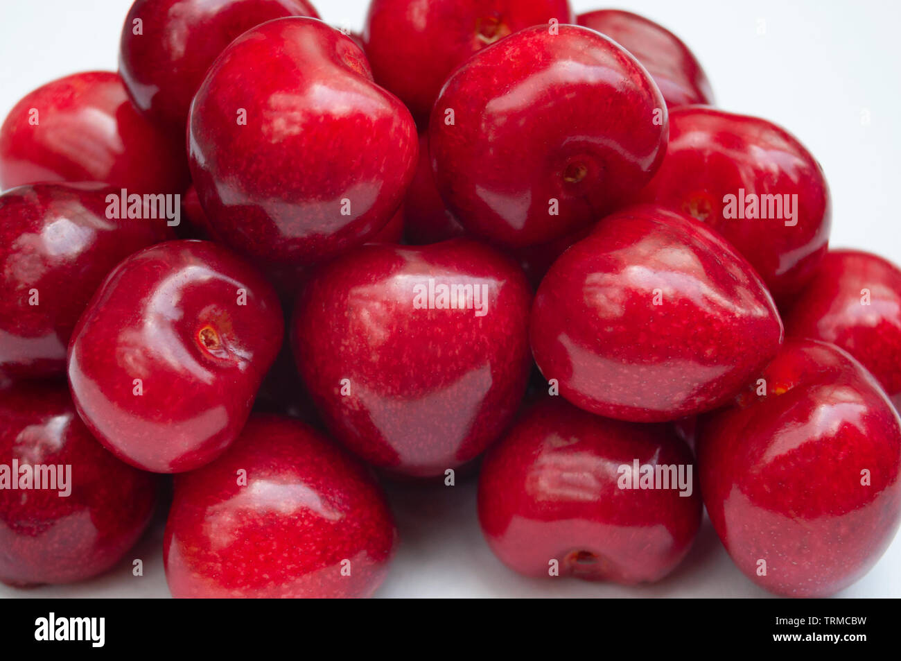 Cherries pile macro on white background Stock Photo