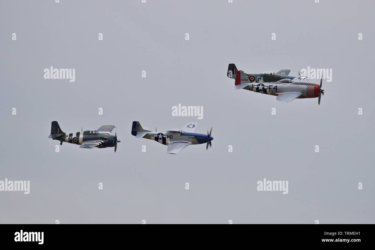 P-47 Thunderbolt, Wildcat and two P-51 Mustangs performing a special flypast at IWM Duxford to commemorate the 75th anniversary of D-Day Stock Photo