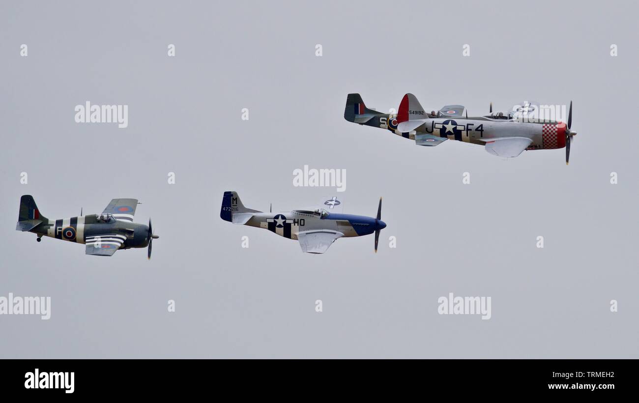 P-47 Thunderbolt, Wildcat and two P-51 Mustangs performing a special flypast at IWM Duxford to commemorate the 75th anniversary of D-Day Stock Photo
