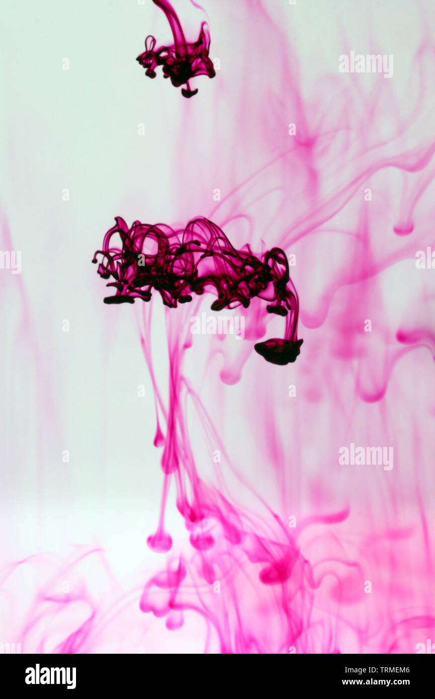Coloured ink swirling in water Stock Photo