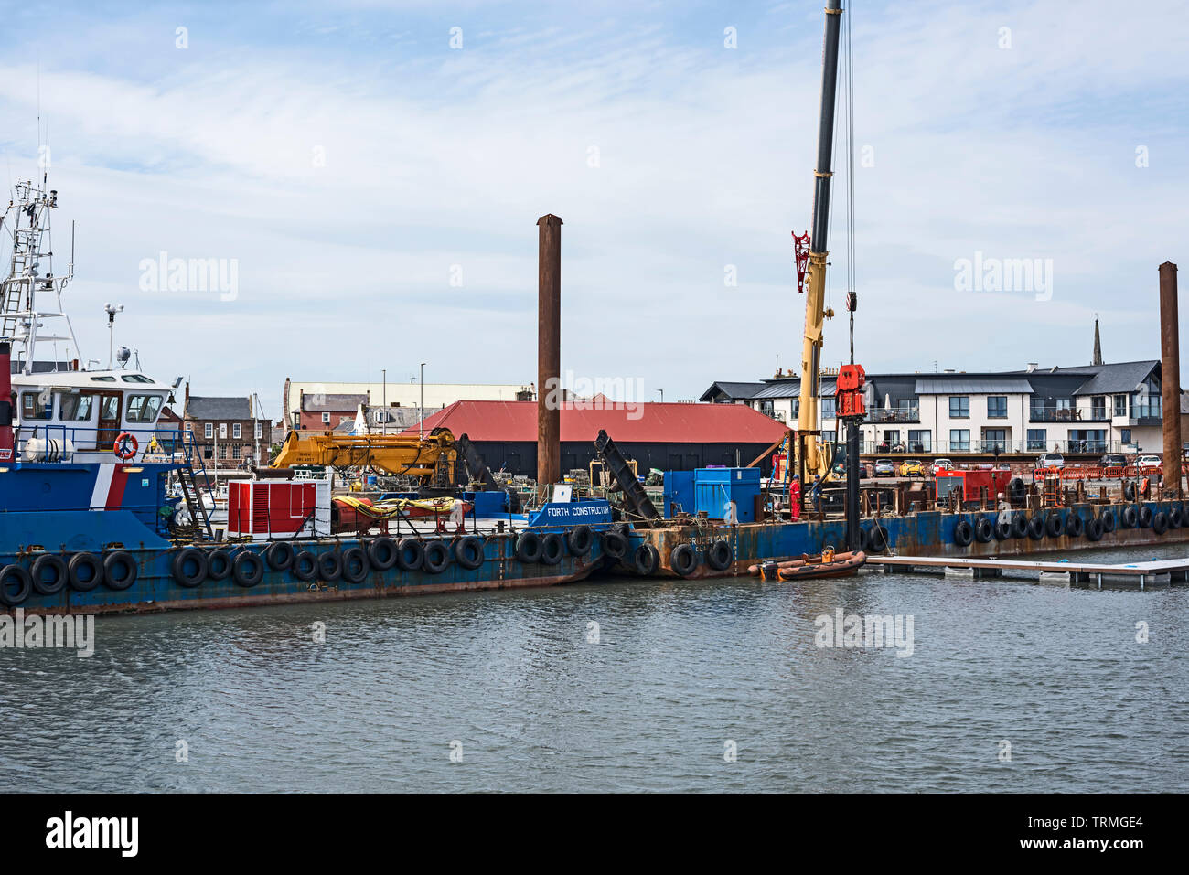 Piling barge drilling in pontoon pile in Arboath harbour, Angus, Scotland, UK for new mooring pontoons. Stock Photo