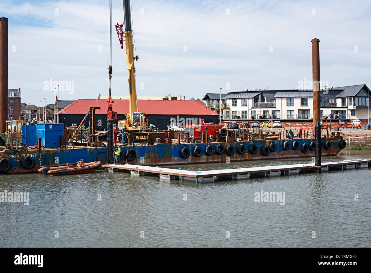 Piling barge drilling in pontoon pile in Arboath harbour, Angus, Scotland, UK for new pontoon Stock Photo