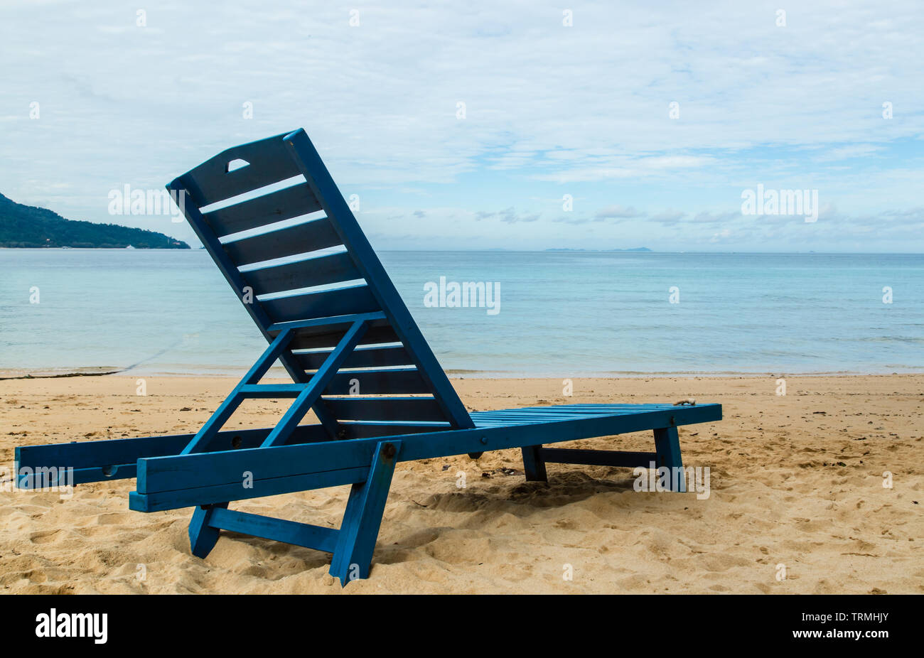 https://c8.alamy.com/comp/TRMHJY/blue-wood-chair-on-sands-face-to-sea-TRMHJY.jpg