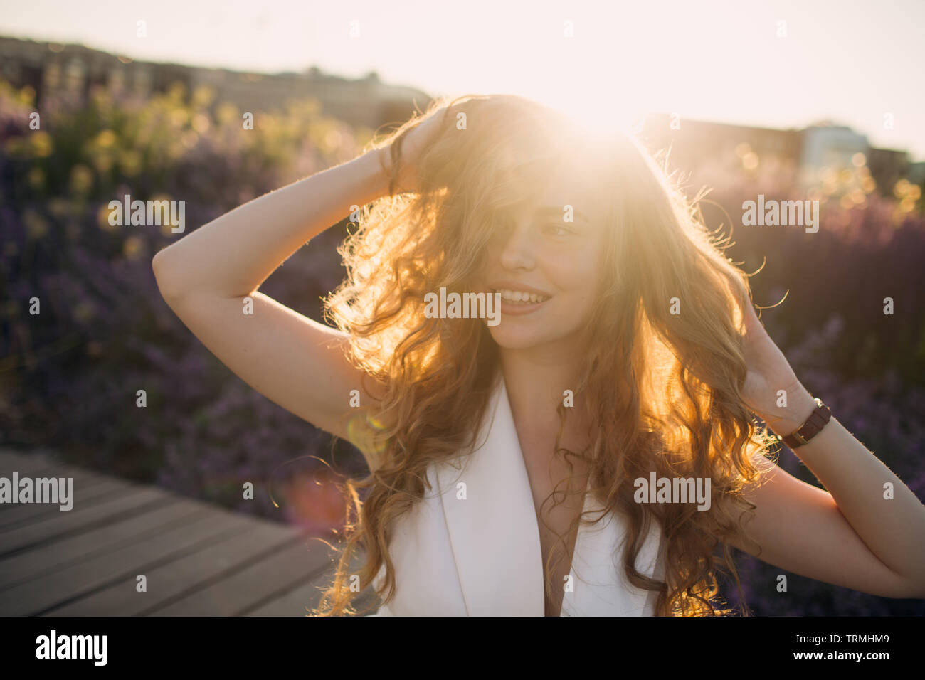 Portrait of young positive woman with curly hair Stock Photo - Alamy