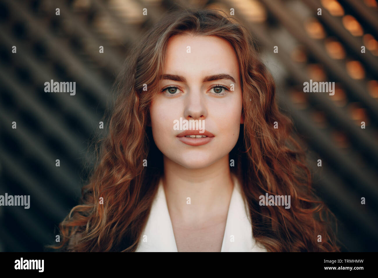 Portrait of young positive woman with curly hair Stock Photo - Alamy