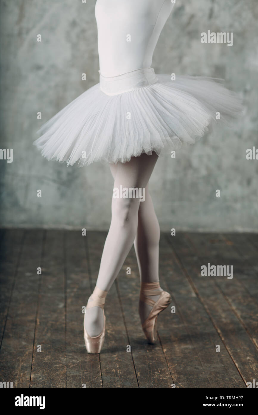 Ballerina in ballroom. woman ballet dancer, legs and pointe shoes and white tutu. Ballet concept Stock Photo - Alamy