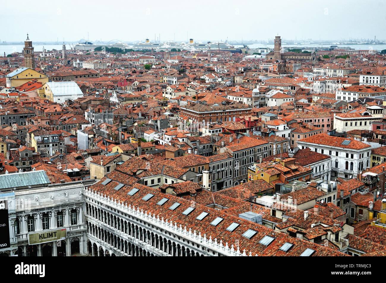 The rooftops of Venice with the port in the distance crowded with large cruise liners, Italy Europe EU Stock Photo