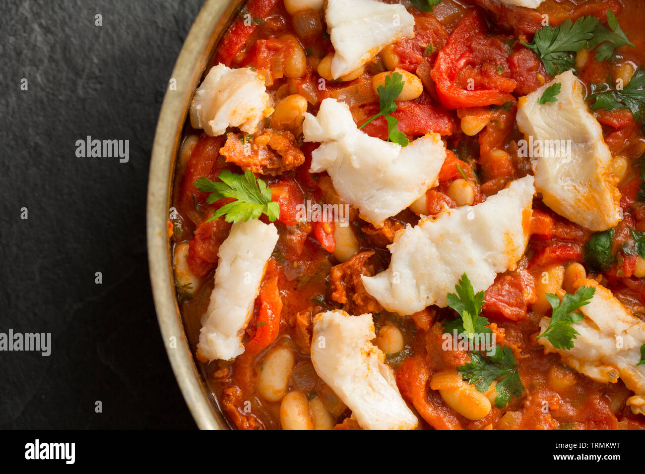 A pollack and chorizo sausage fish stew made with tomatoes, roasted red