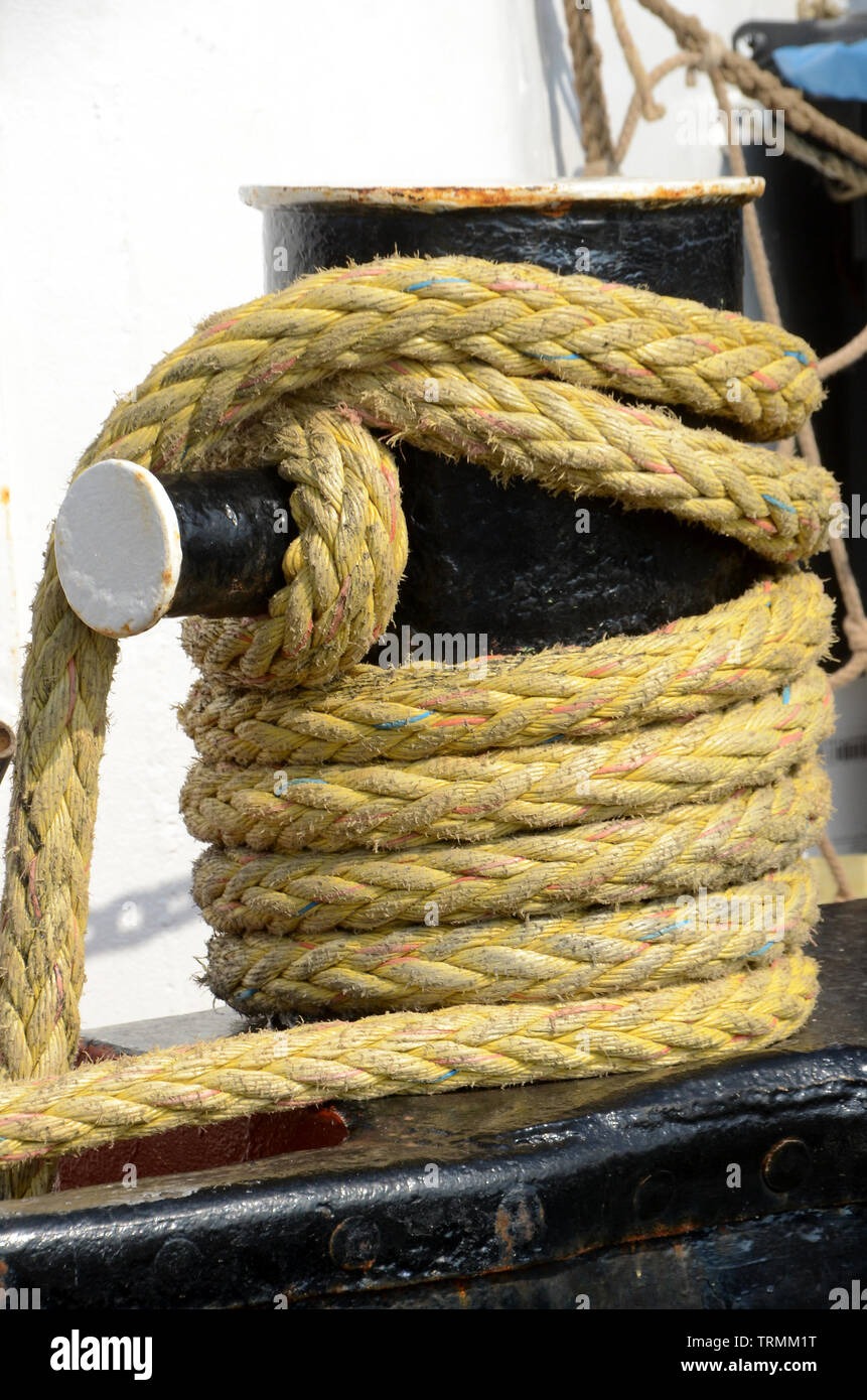 Heavy mooring rope wound around a bollard Stock Photo Alamy