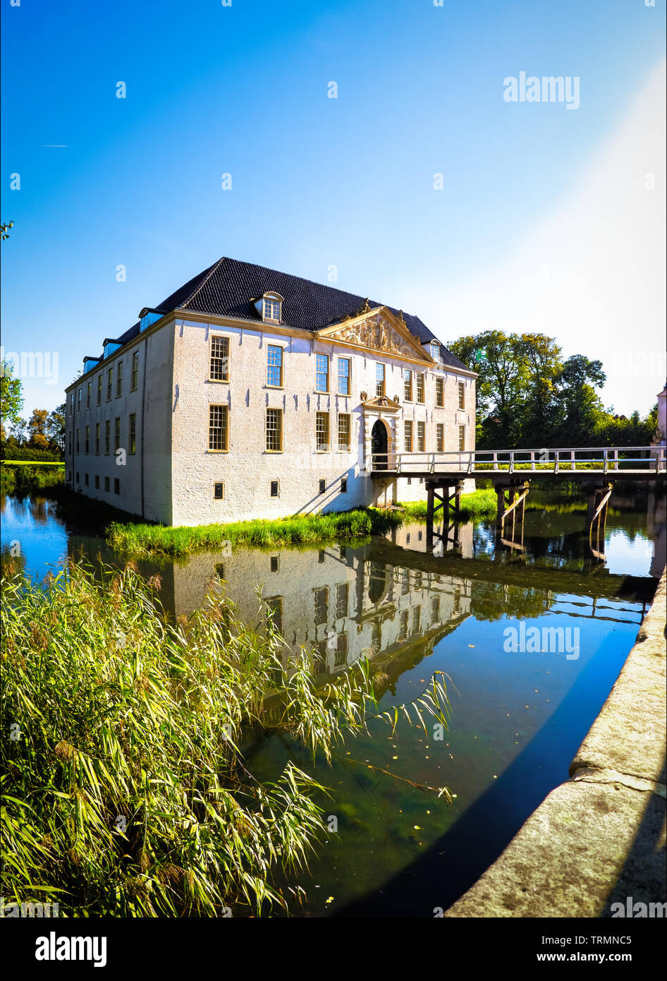 Dornum, Germany, 09/30/2015: The historic Norderburg castle in Dornum in the state of Lower Saxony. The water castle is surrounded by a water ditch. I Stock Photo