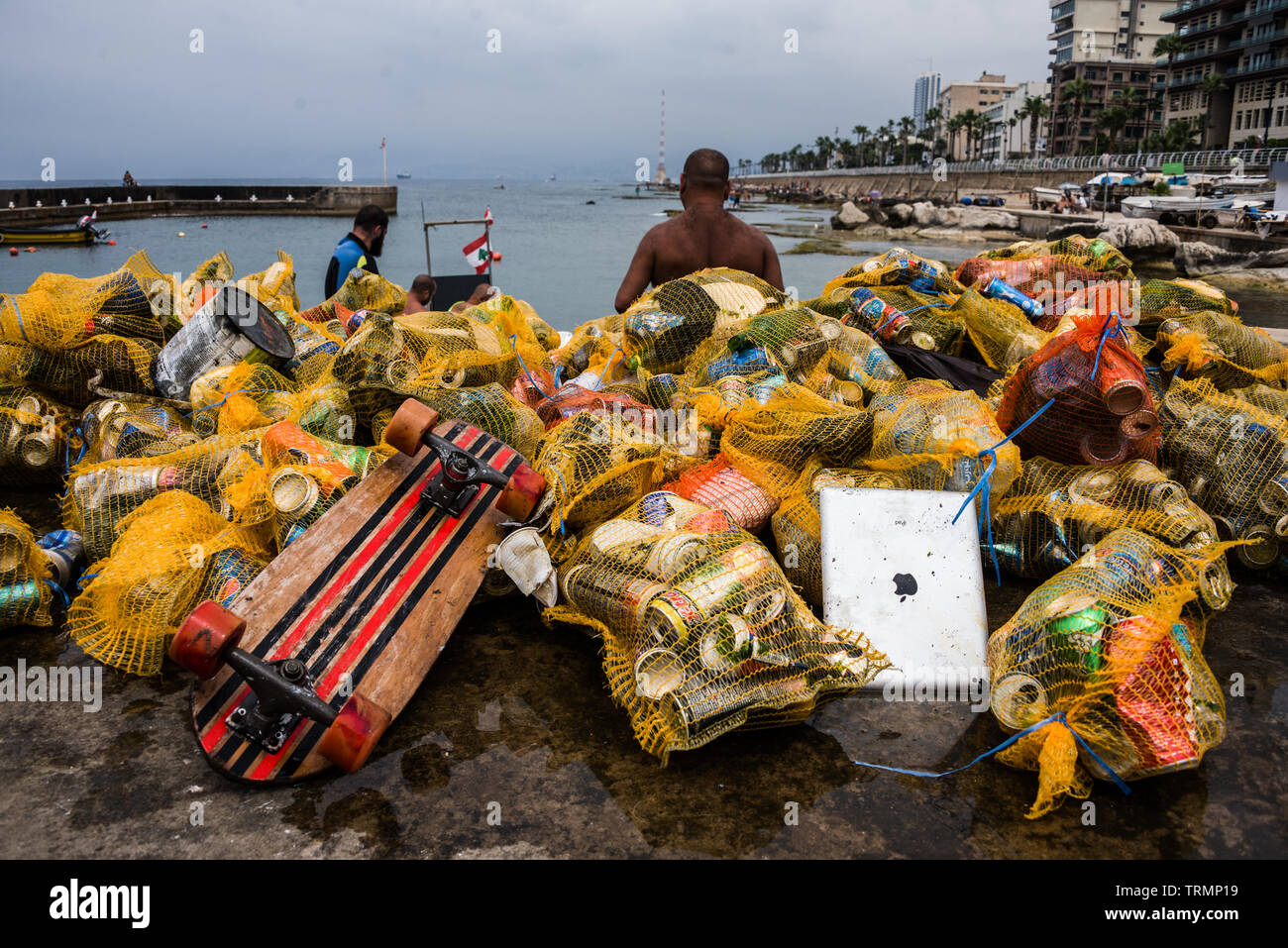 Calypso Dive Club members seen here clearing trash from the sea along Beirut's Corniche. Lebanese people came out en masse Sunday, to help out with a National Beach Cleanup Day spearheaded by the Lebanese Minister for Environment. Not only did they collect trash from their beaches at over 150 locations, teams of scuba divers also spent their Sunday underwater, clearing up everyone's waste from the ocean floor. Beirut, Lebanon, 9//6/2019 Stock Photo