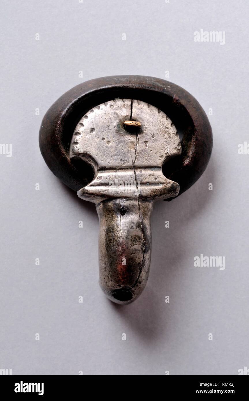 Belt  buckle , bronze and silver, kidney-shaped needle scutiform base decorated with incisions. Length 3, 8 cm Width 2, 5 cm thickness 1 cm (6 th CE ) Stock Photo
