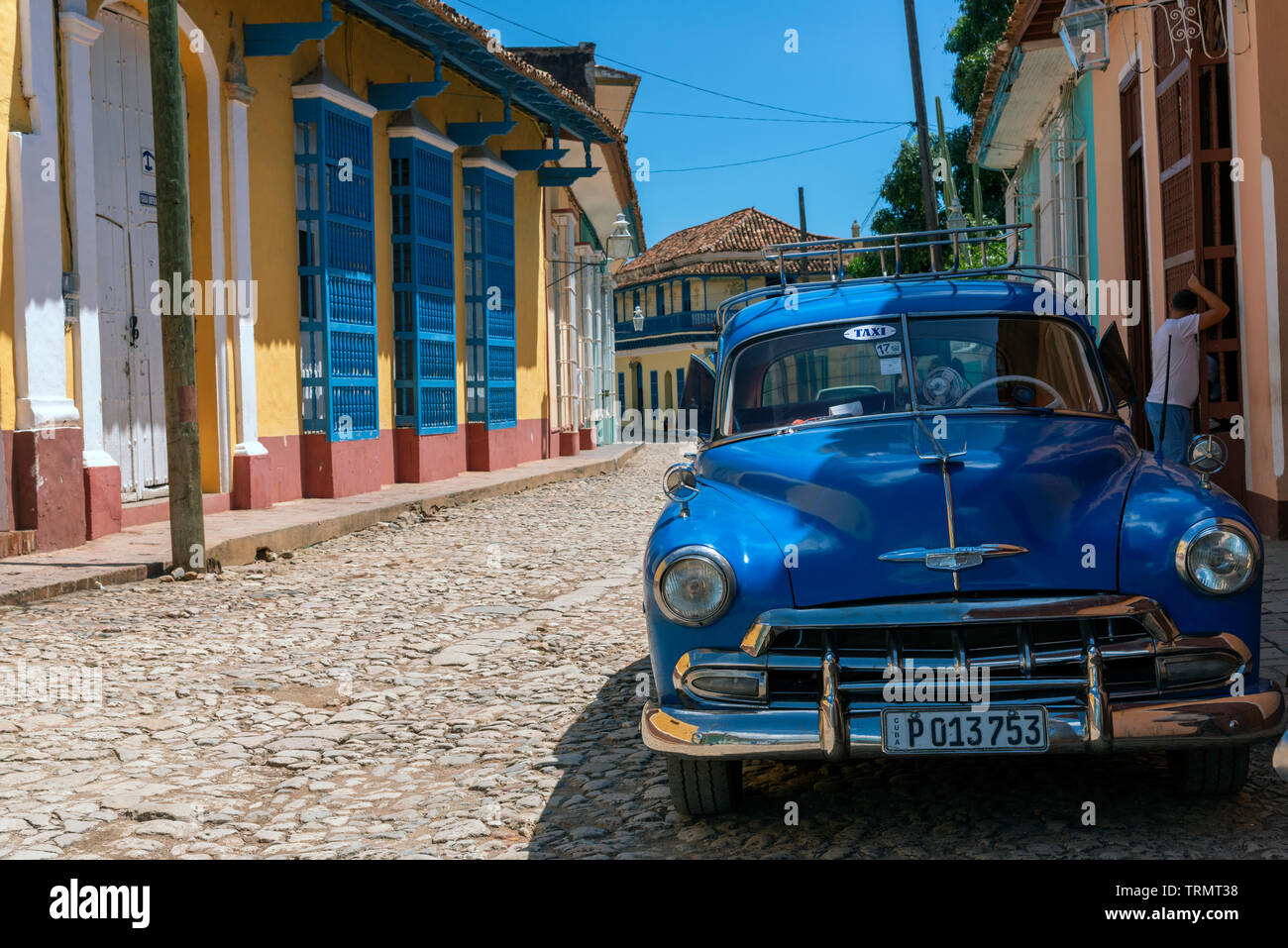 Classic American blue taxi parked on a picturesque  cobblestone street in the old colonial town of Trinidad, Sancti Spiritus, Cuba, Caribbean Stock Photo