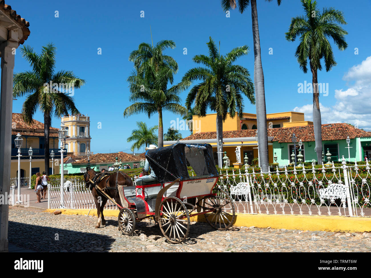 Horse carriage driving through Plaza Mayor, the main central square, of tthe UNESCO town of Trinidad, Sancti Spiritus Province, Cuba,Caribbean Stock Photo