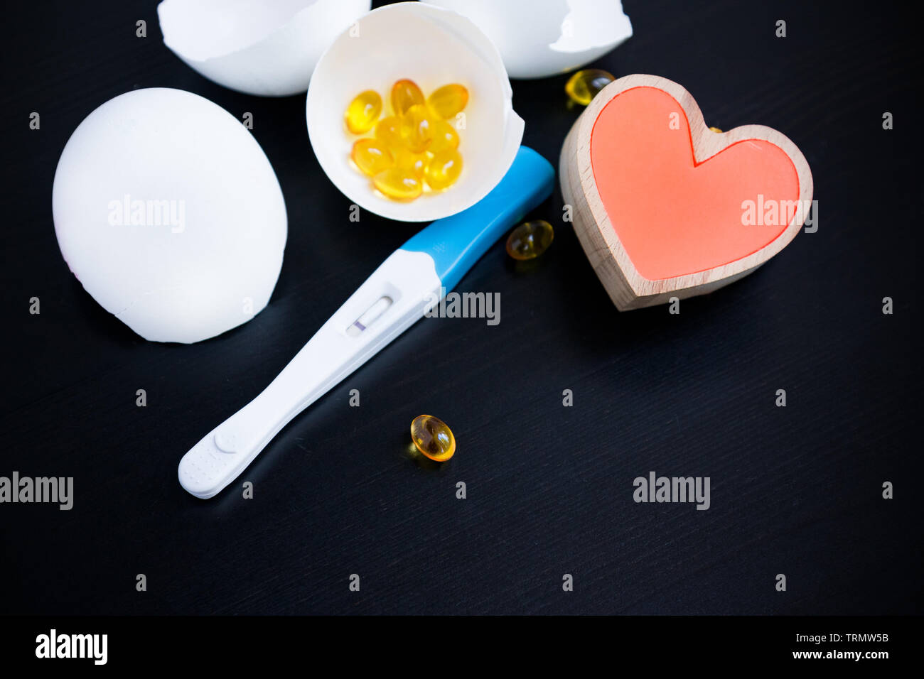 Infertility. Negative pregnancy test, pills and heart, eggshell on
