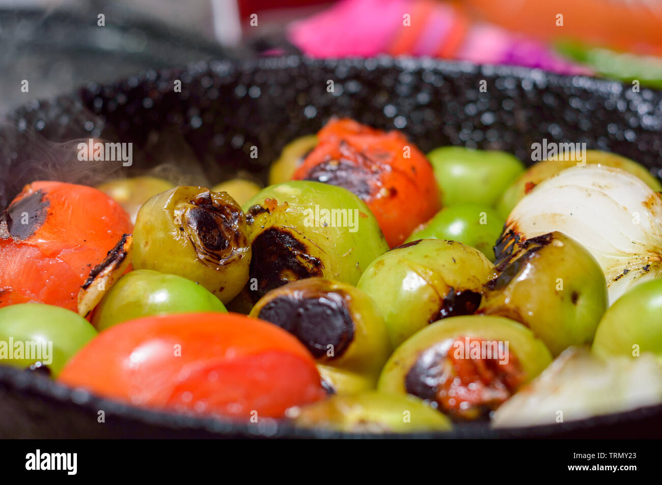 Cooking Mexican green sauce, salsa verde, made with tomatillos