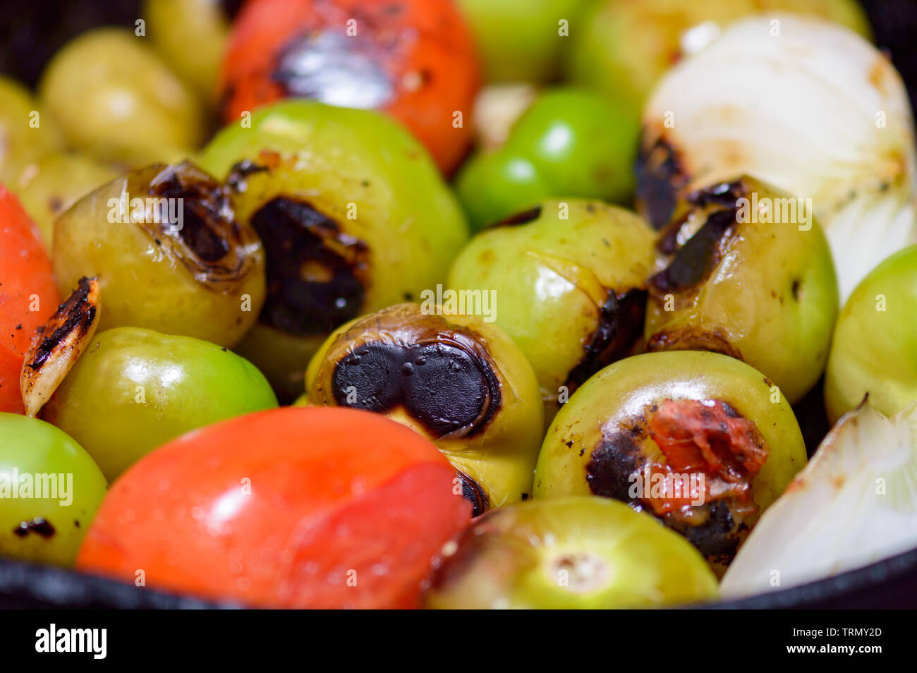 Cooking Mexican green sauce, salsa verde, made with tomatillos