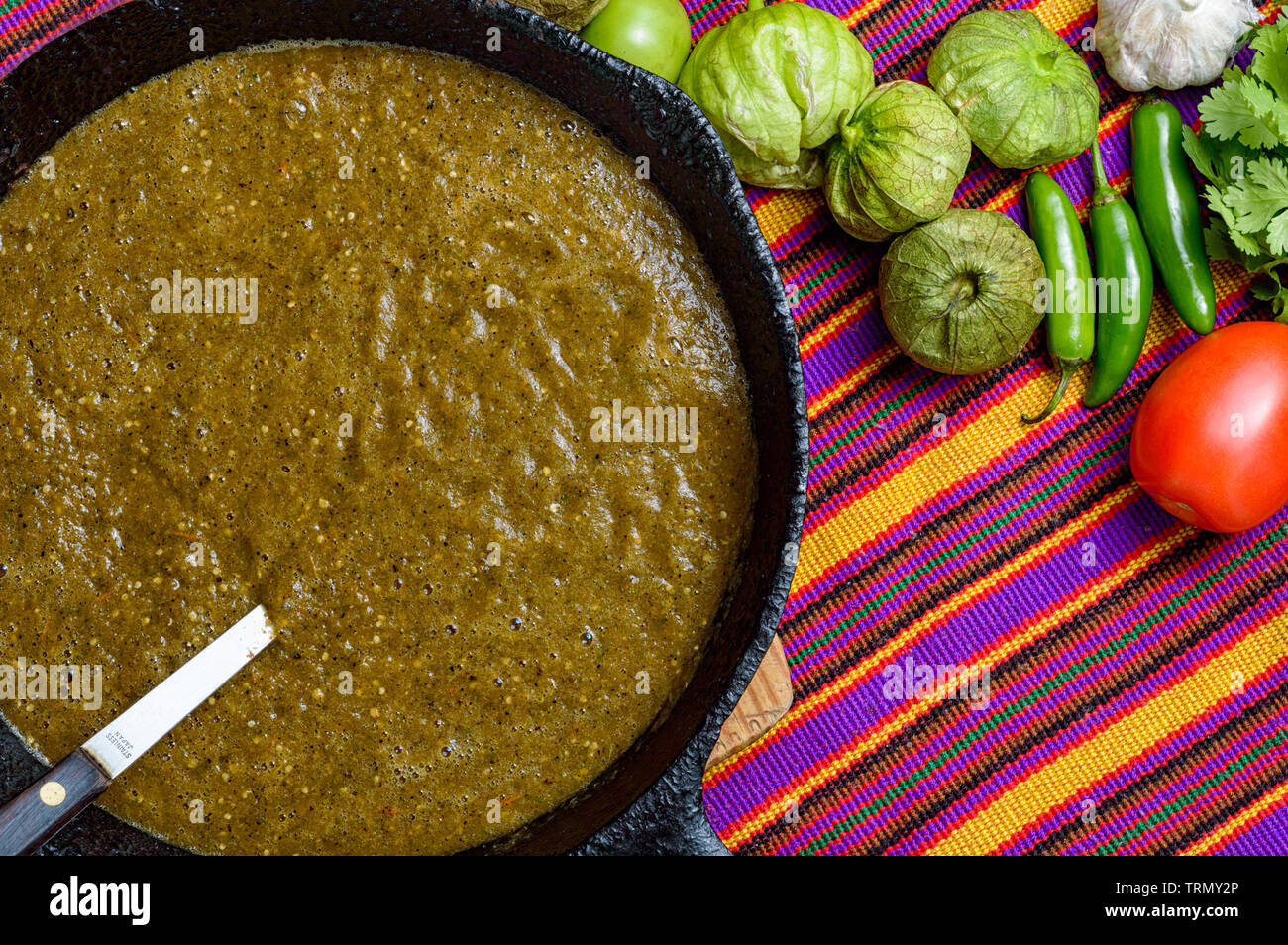 Cooking Mexican green sauce, salsa verde, made with tomatillos