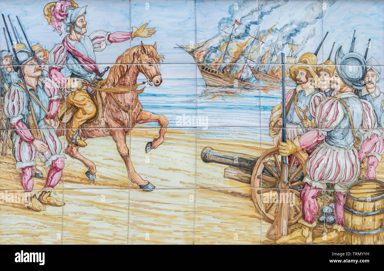 Badajoz, Spain - April 24th, 2019: Hernan Cortes burns his vessels arriving Mexico. Conquest of Aztec Empire scene. Glazed tiles wall Stock Photo