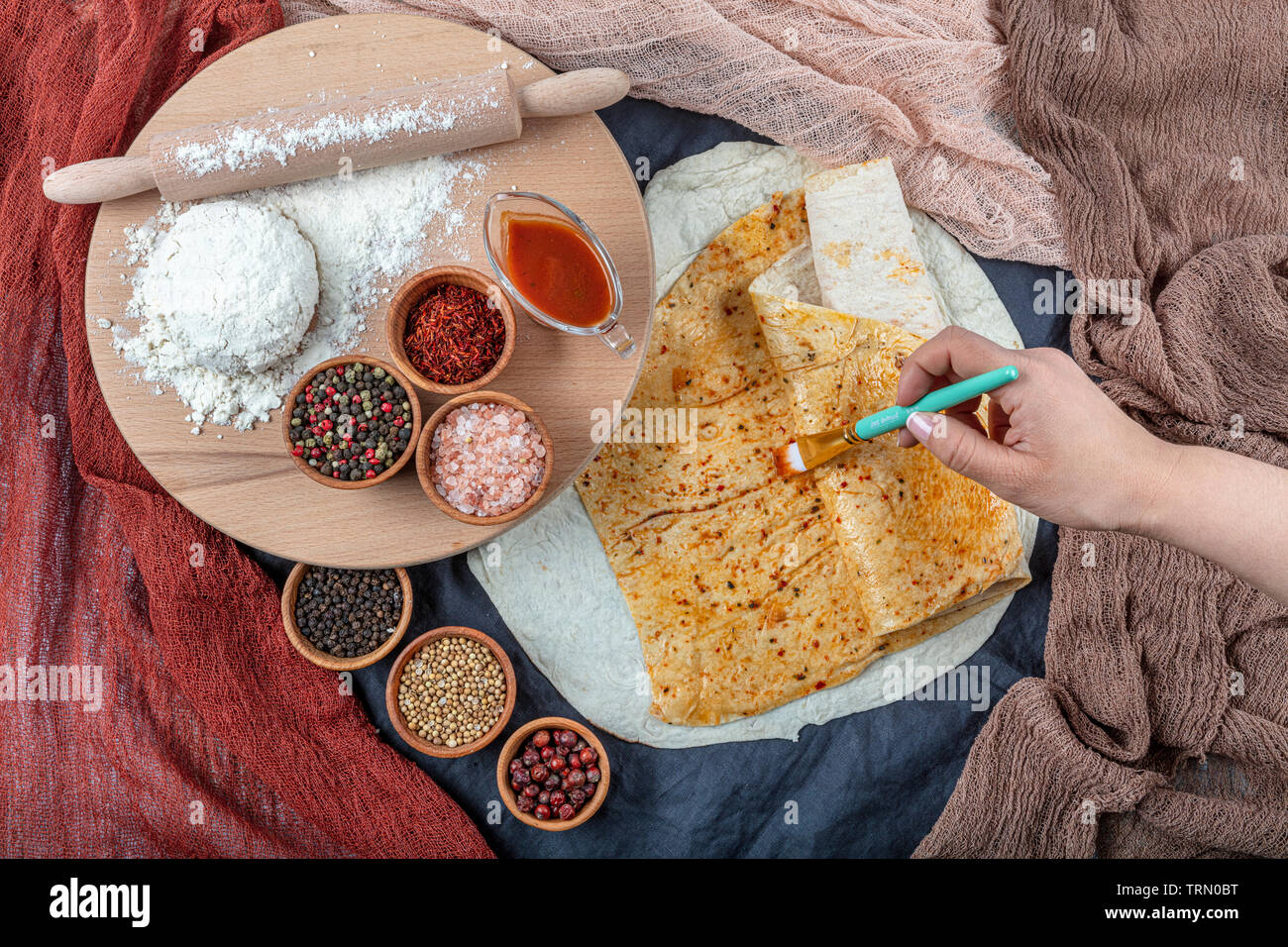 Cooking traditional Turkish Yufka (  pastries, pancake) on the stove. Closeup on the bake. Handmade pastries concept. Stock Photo