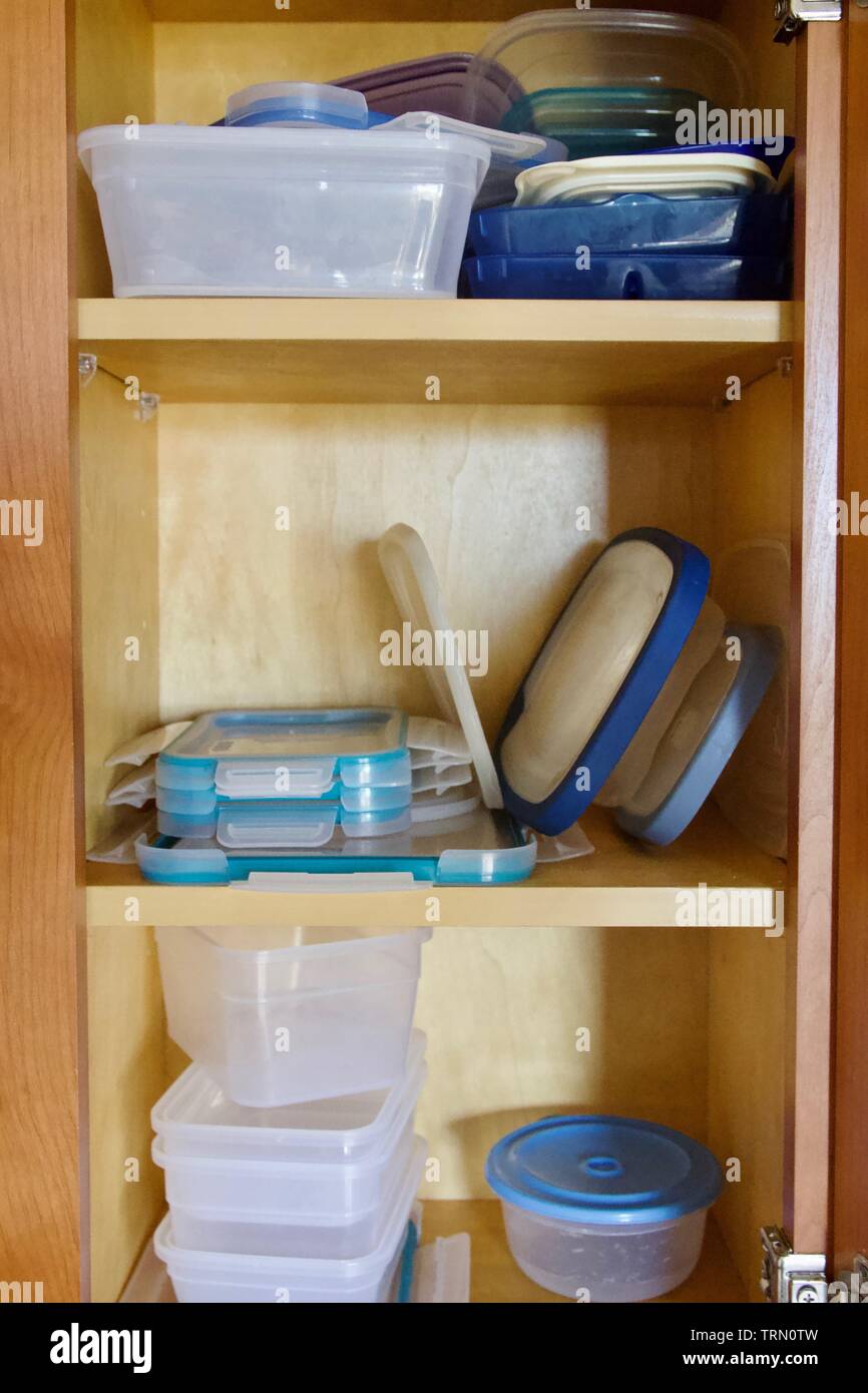 A cupboard full of plastic food containers Stock Photo Alamy