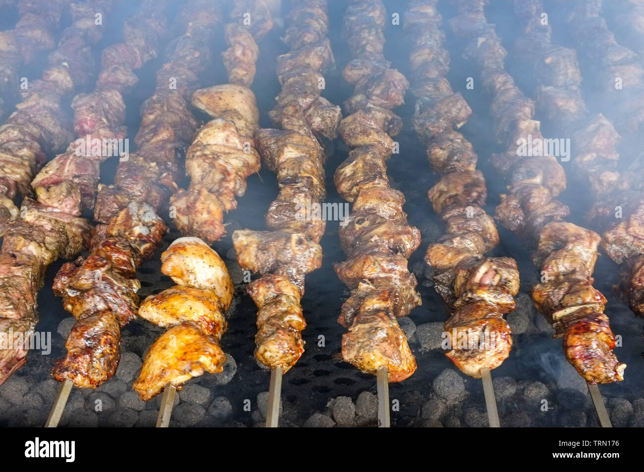 Meat cooking over BBQ at the Glenti Greek Festival in Darwin, Northern Territory, Australia. Stock Photo