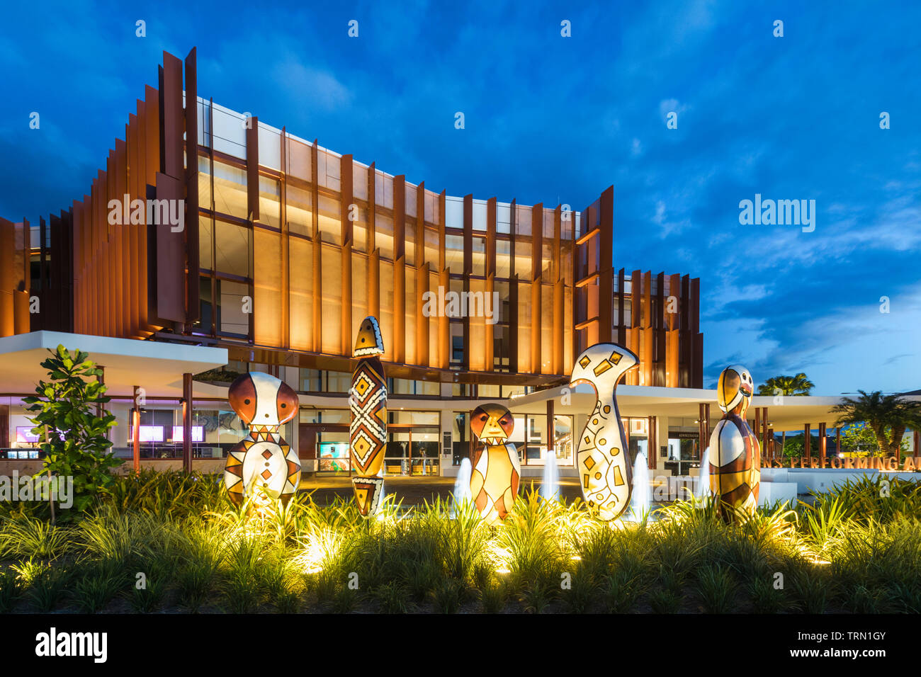 'Bagu' indigenous sculptures in front of the Cairns Performing Arts Centre at twilight, Cairns, Queensland, Australia Stock Photo