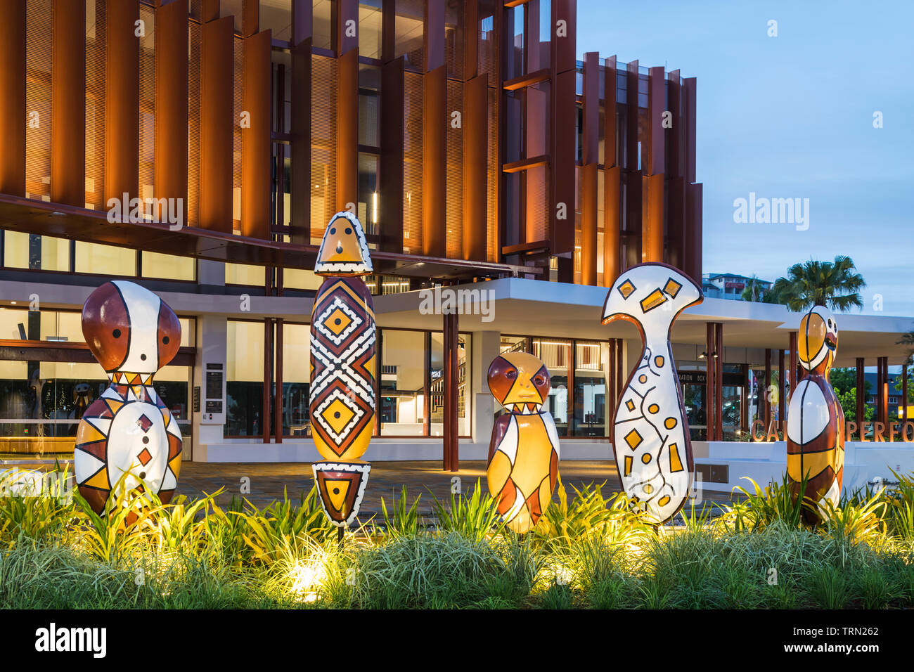 'Bagu' indigenous sculptures in front of the Cairns Performing Arts Centre at twilight, Cairns, Queensland, Australia Stock Photo