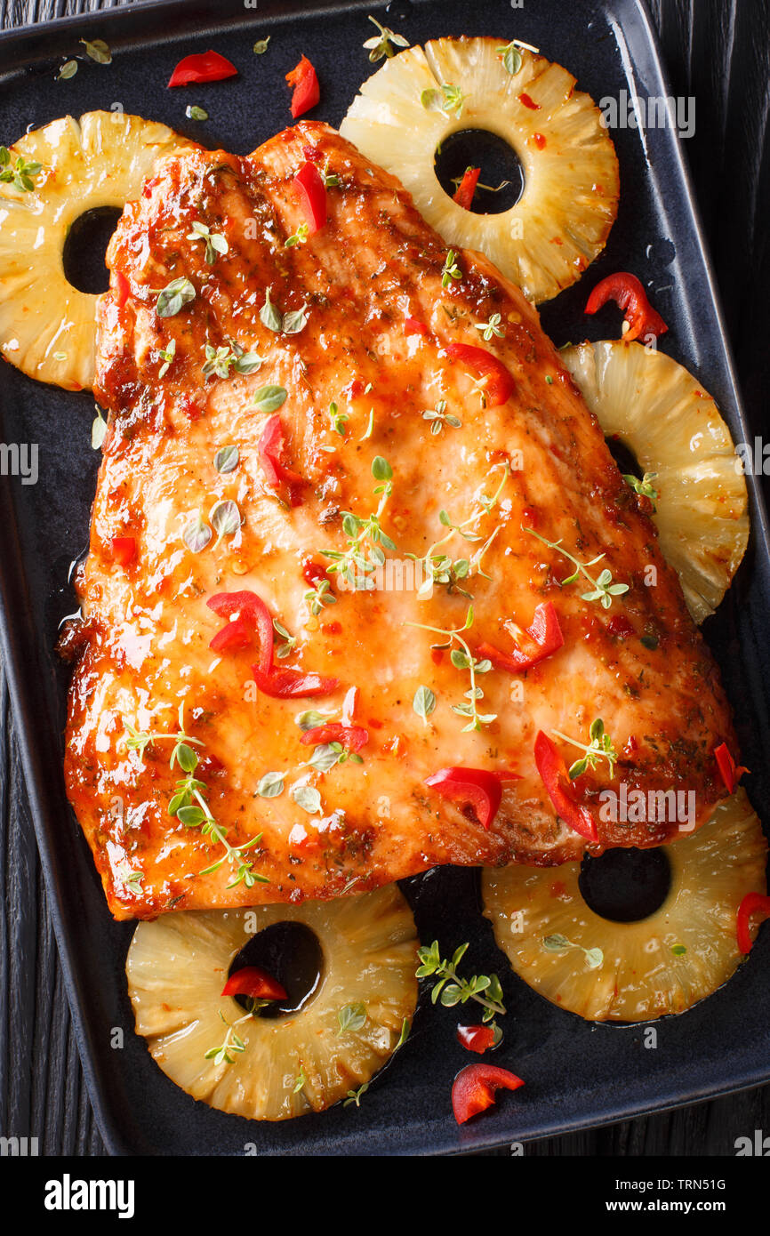 Baked Thai pineapple salmon in a sour-sweet sauce closeup on a plate on the  table. Vertical top view from above Stock Photo - Alamy