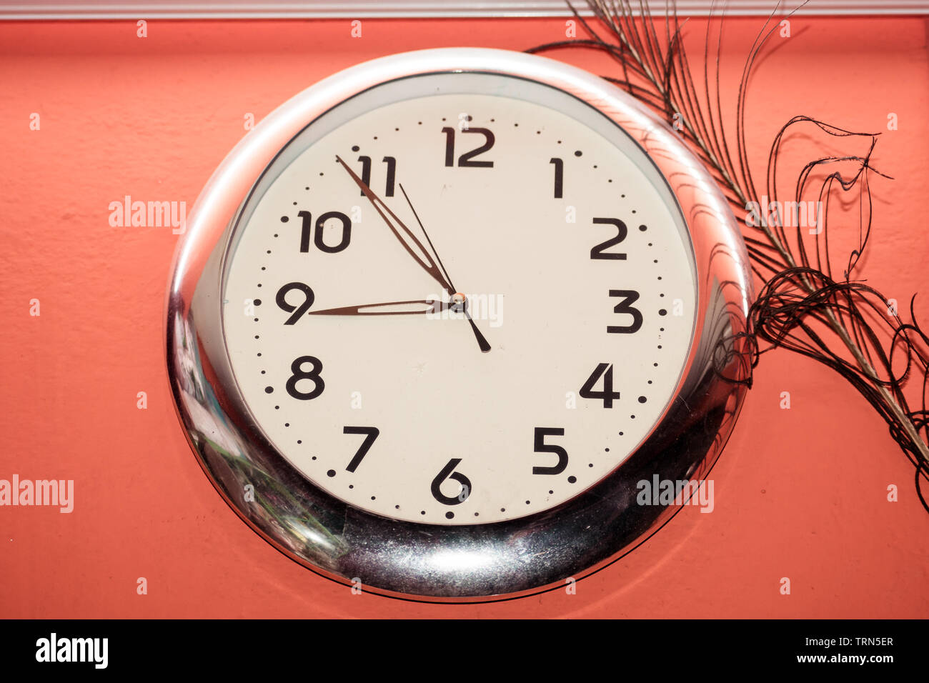 Antique Simple design and decoration classic clock hang isolated on red