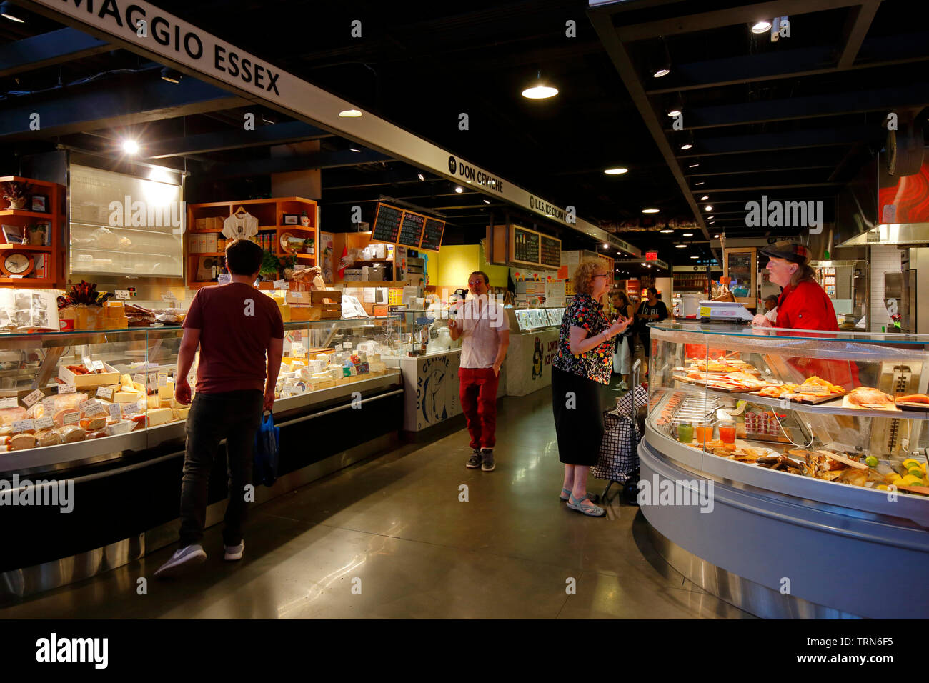 Shoppers and hipsters inside Essex Market, June 2019.  Lower East Side, New York City Stock Photo
