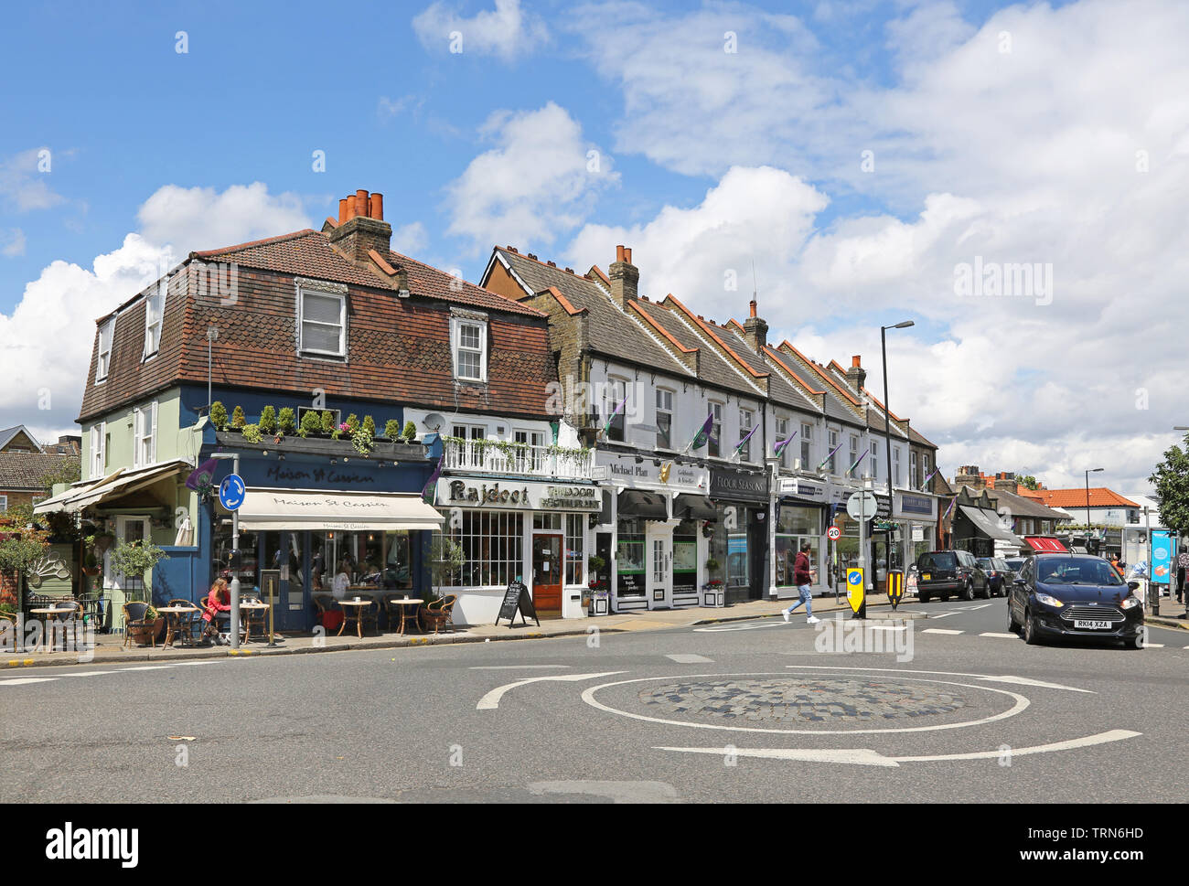 Wimbledon Village, a wealthy area of southwest London, near the famous tennis club. Shows restaurants on the junction of High Street and Church Road Stock Photo