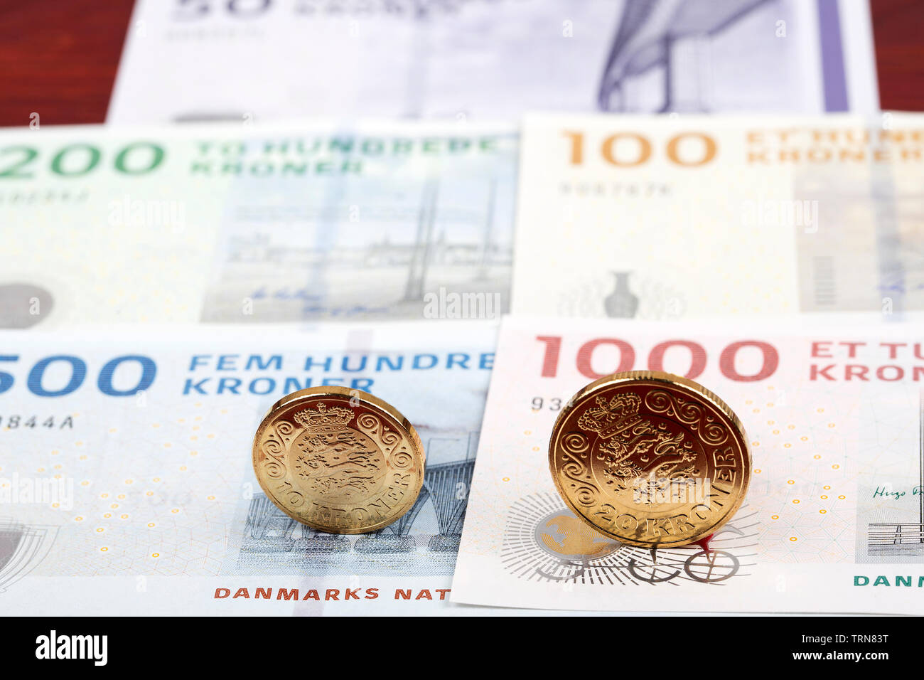 Danish coins on the background of banknotes Stock Photo