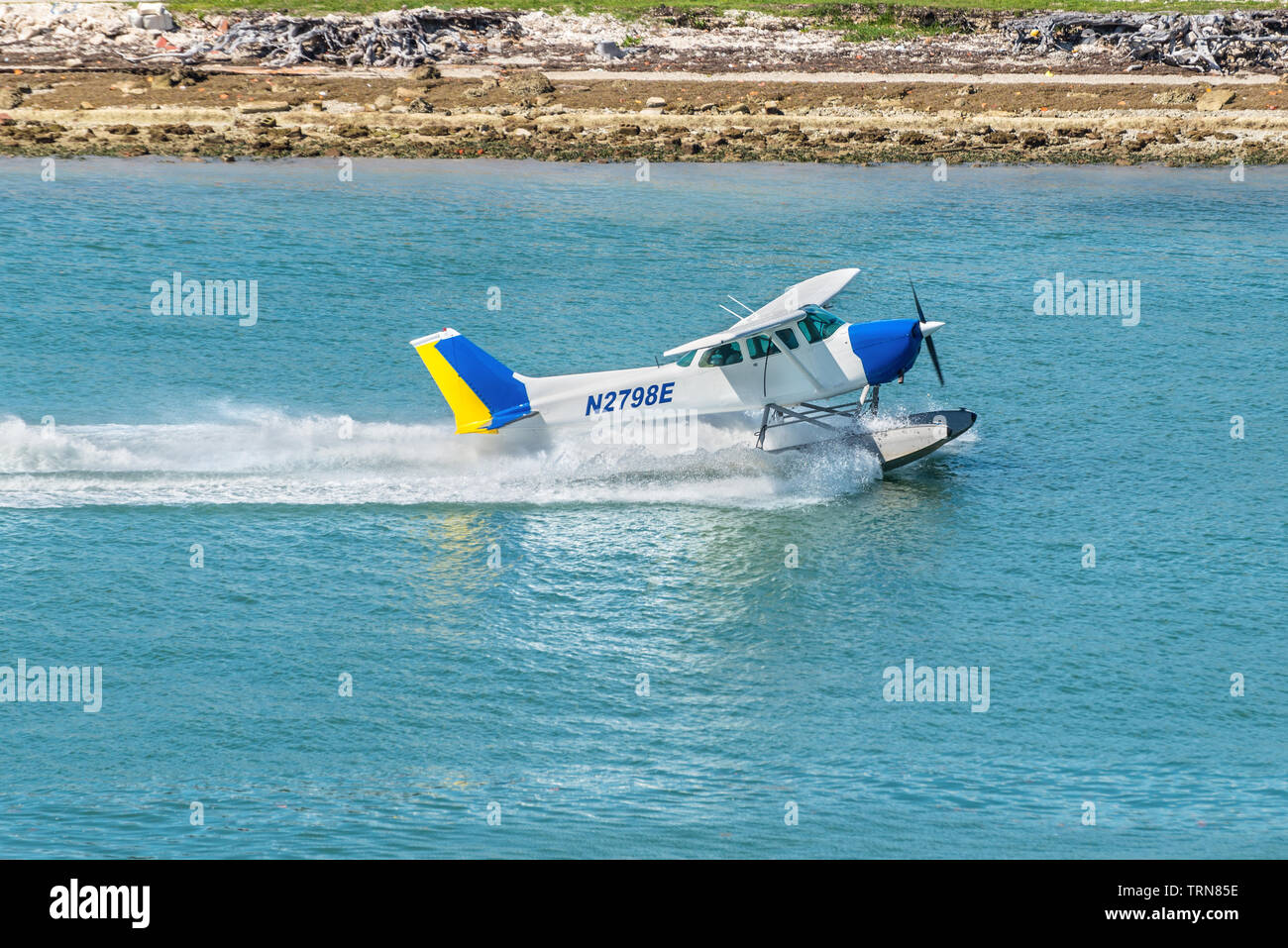 Miami, FL, United States - April 20, 2019: The Seaplane Cessna 172N Skyhawk takes off in the Miami Main channel next to the cruise port of Miami, Flor Stock Photo
