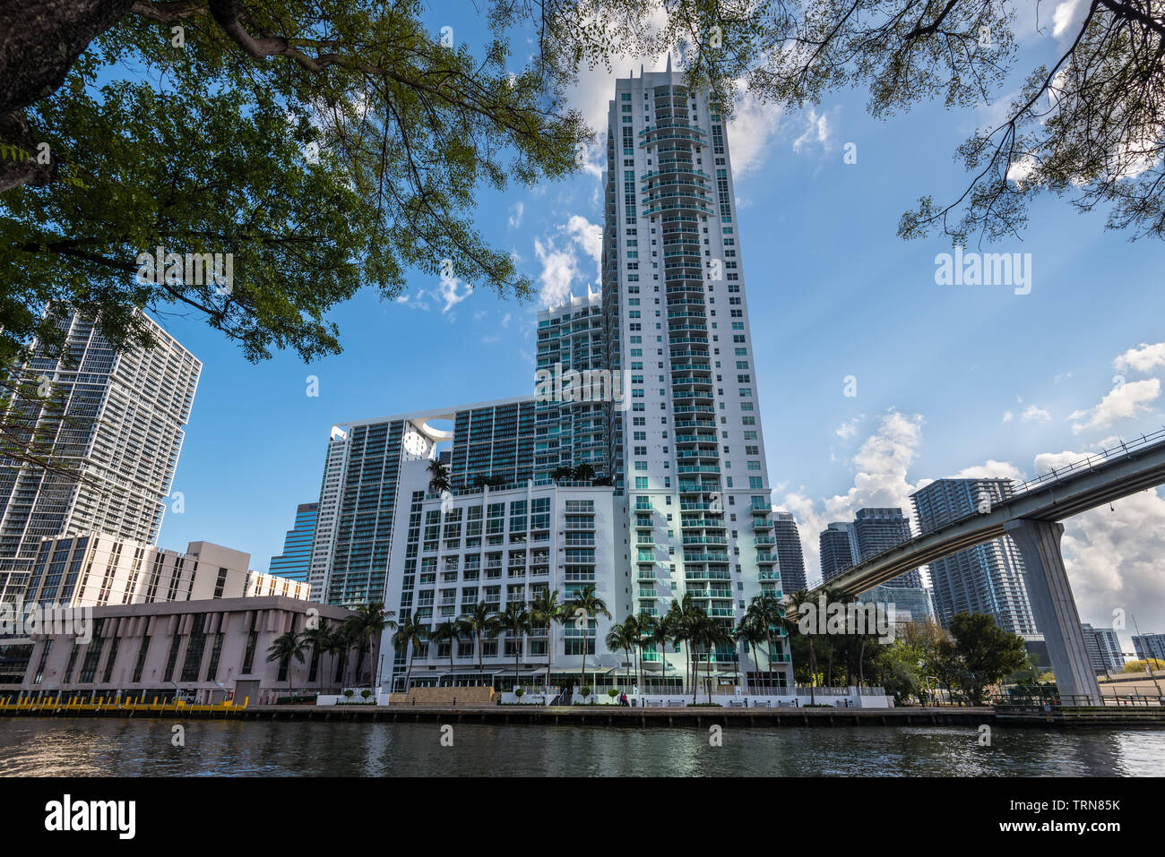 Miami, FL, USA - April 20, 2019: View of downtown financial and residential buildings and Brickell key on a spring day with blue sky and green waters Stock Photo