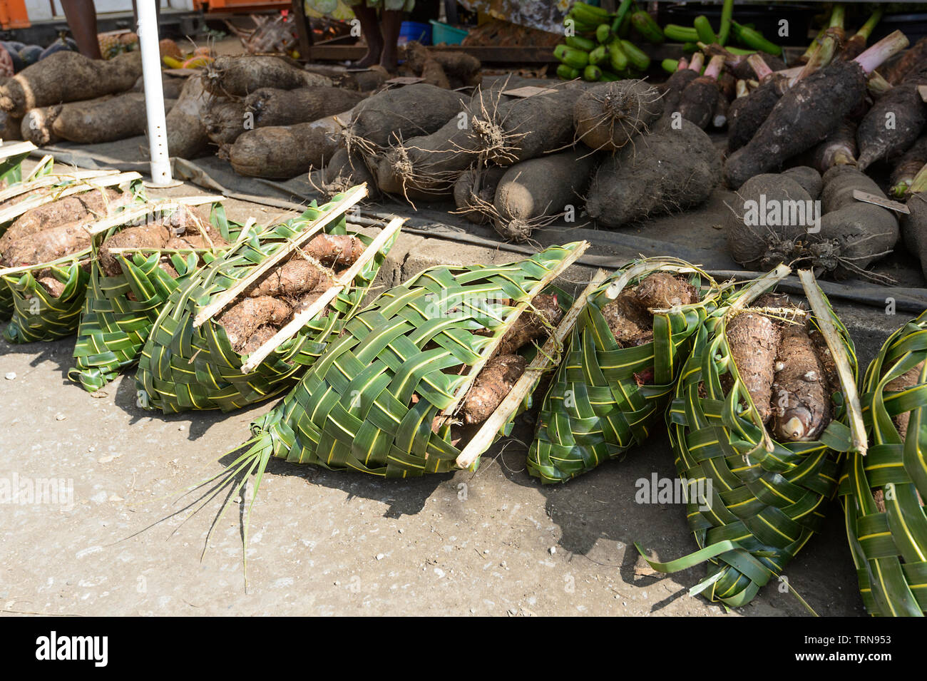 Woven basket containing root vegetables for sale at the market in Port Vila, Vanuatu, Melanesia Stock Photo