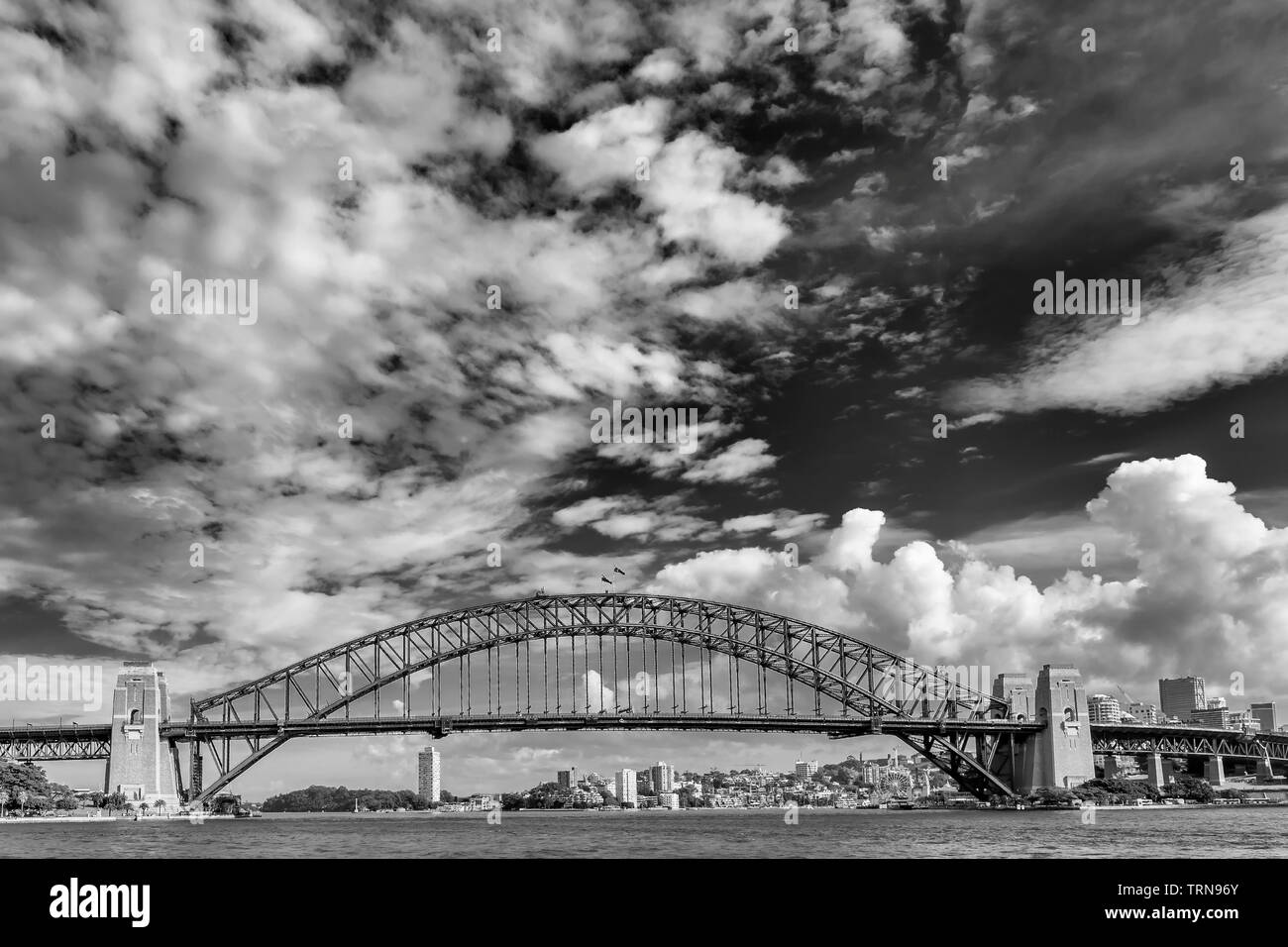 Beautiful black and white view of the Sydney Harbour Bridge, Australia, against a dramatic sky Stock Photo