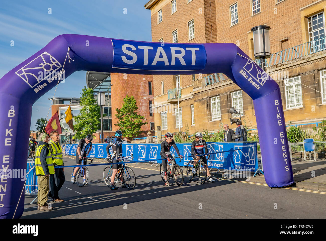 June 2019, Norwich 100 bike ride: Cyclists lined up at the start waiting  for the timing machine to start the countdown to the start of their 100mile  c Stock Photo - Alamy
