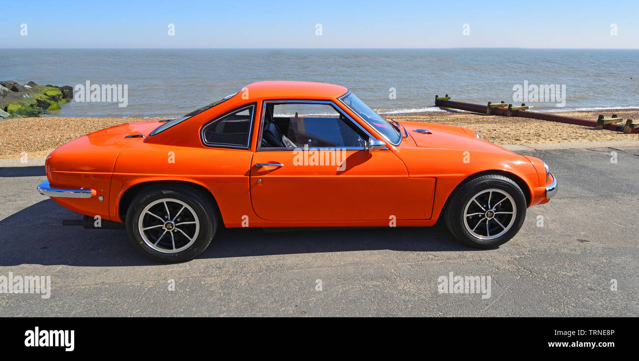 Classic Orange Ginetta Motor Car Parked on Seafront  Promenade. Stock Photo