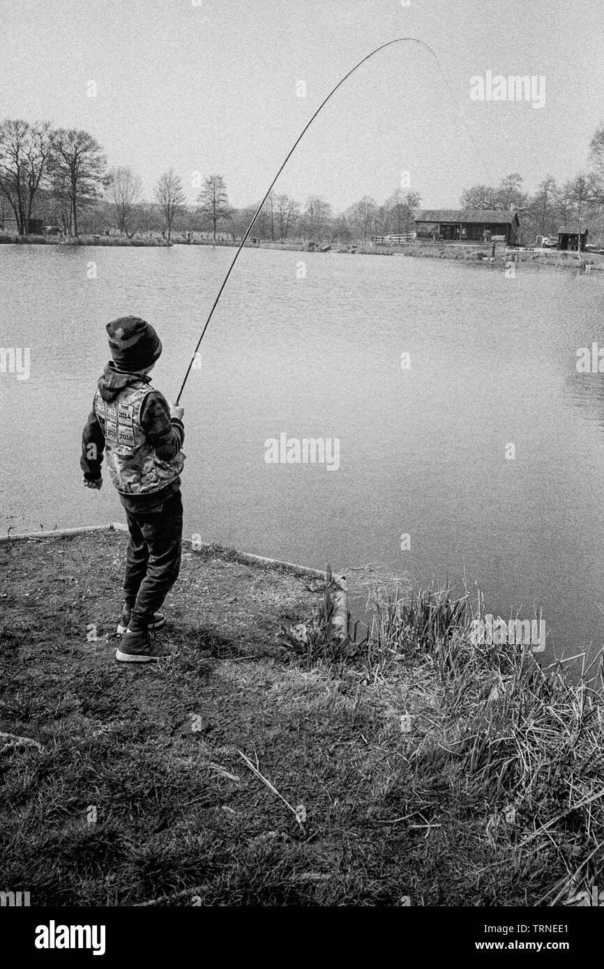 Ten year old boy fishing at Dever Springs trout fishery, Winchester,  Hampshire, England, United Kingdom Stock Photo - Alamy