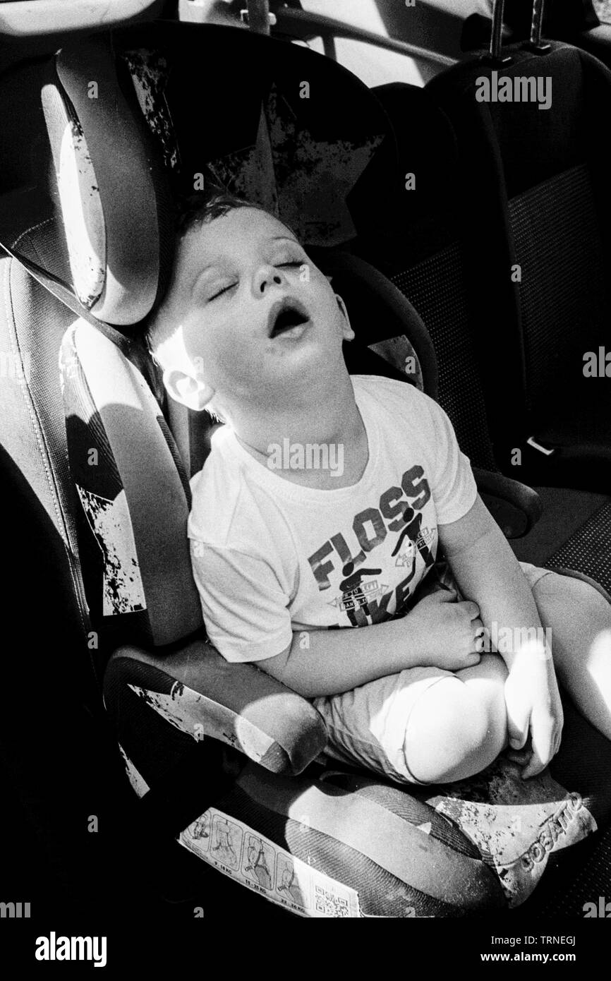 Two year old boy sleeping in the car, Medstead, Alton, Hampshire, England, United Kingdom. Stock Photo