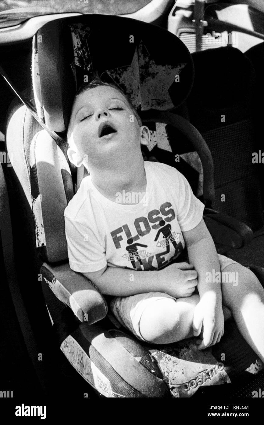 Two year old boy sleeping in the car, Medstead, Alton, Hampshire, England, United Kingdom. Stock Photo